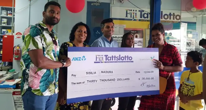 Fiji Tattslotto winner Sisilia Nadura receives a cheque of $30,000 after winning the Fijji Tattslotto Fiji Only.