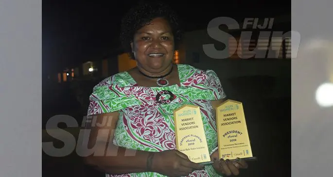 Rakiraki Market Vendors Association President Varanisese Maisamoa holds her Presidents Award and the group category strategic planning award for the Rakiraki Town Council during the Market Vendors Association awards night at the Tokatoka Resort in Nadi on November 7, 2019. Photo: Salote Qalubau