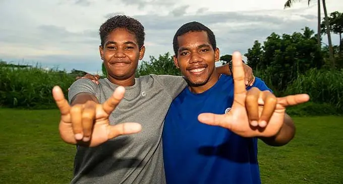 Nineteen-year-old hard to hear athletes Adi Lusiana (left) and Anare Tikomainayalisara signing the words ‘I love you’ after their training at the Toorak playground in Suva on January 9, 2024. Photo: Leon Lord