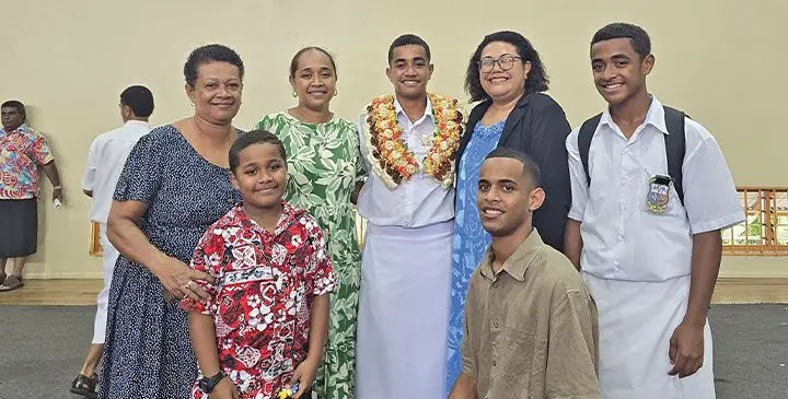 Marist Brothers High School deputy head boy George Taoba, (with garland), surrounded by his family on Febuary 25, 2025.