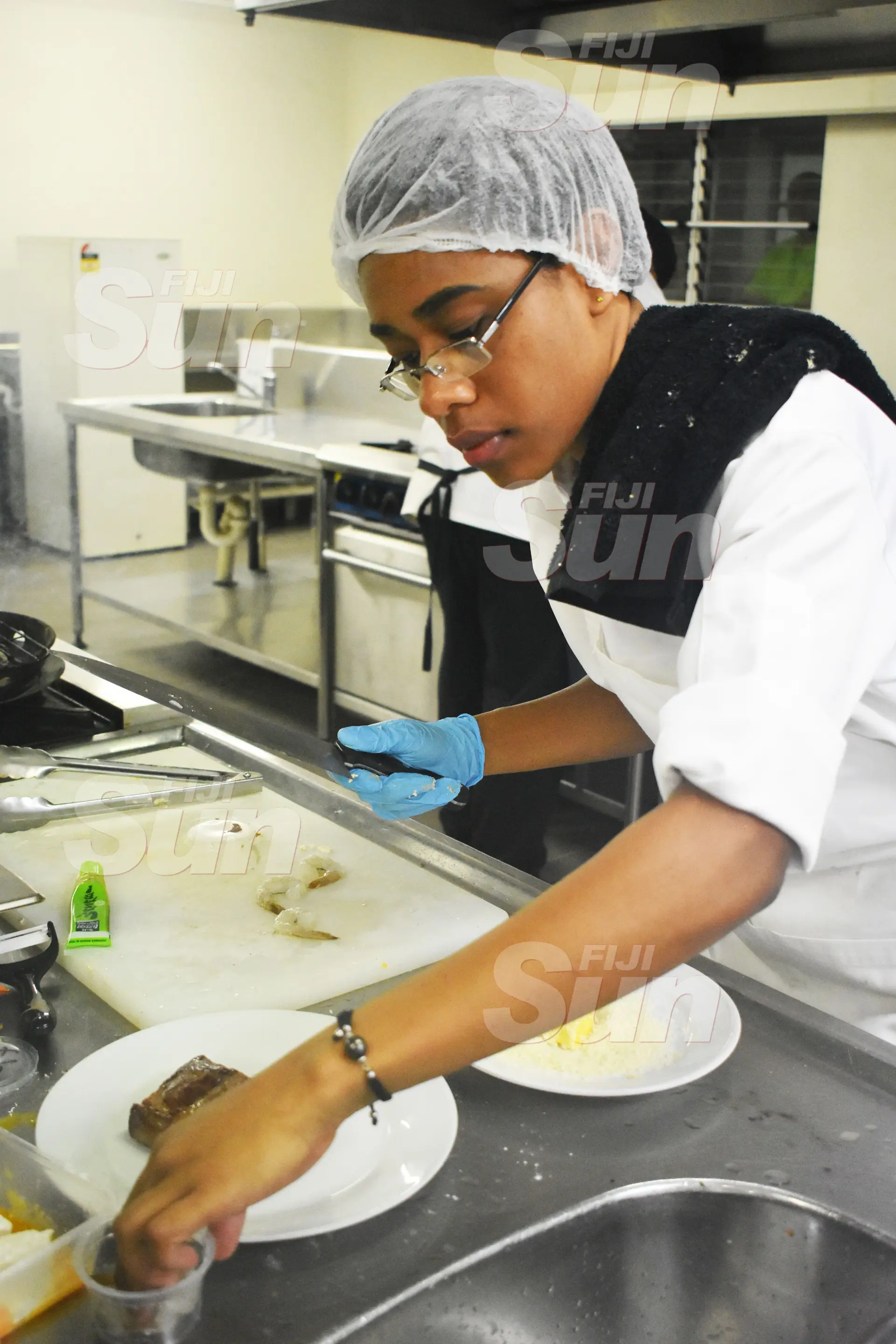 Fiji National University second year student, Merewalesi Banuve preparing her teriyaki surf and turf during the competition on October 22, 2019. Photo: Nicolette Chambers