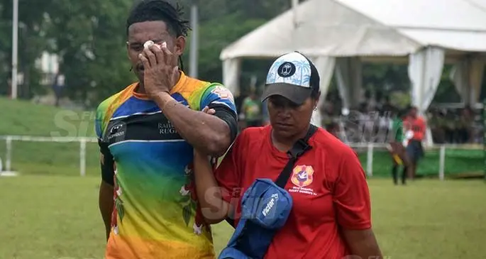 Raiwasa Taveuni player, Manueli Maisamoa, is escorted by a medical official at Prince Charles Park, Nadi, on February 27, 2021.Photo: Waisea Nasokia