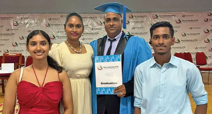 Law graduate Ni Lesh Karan and his family.