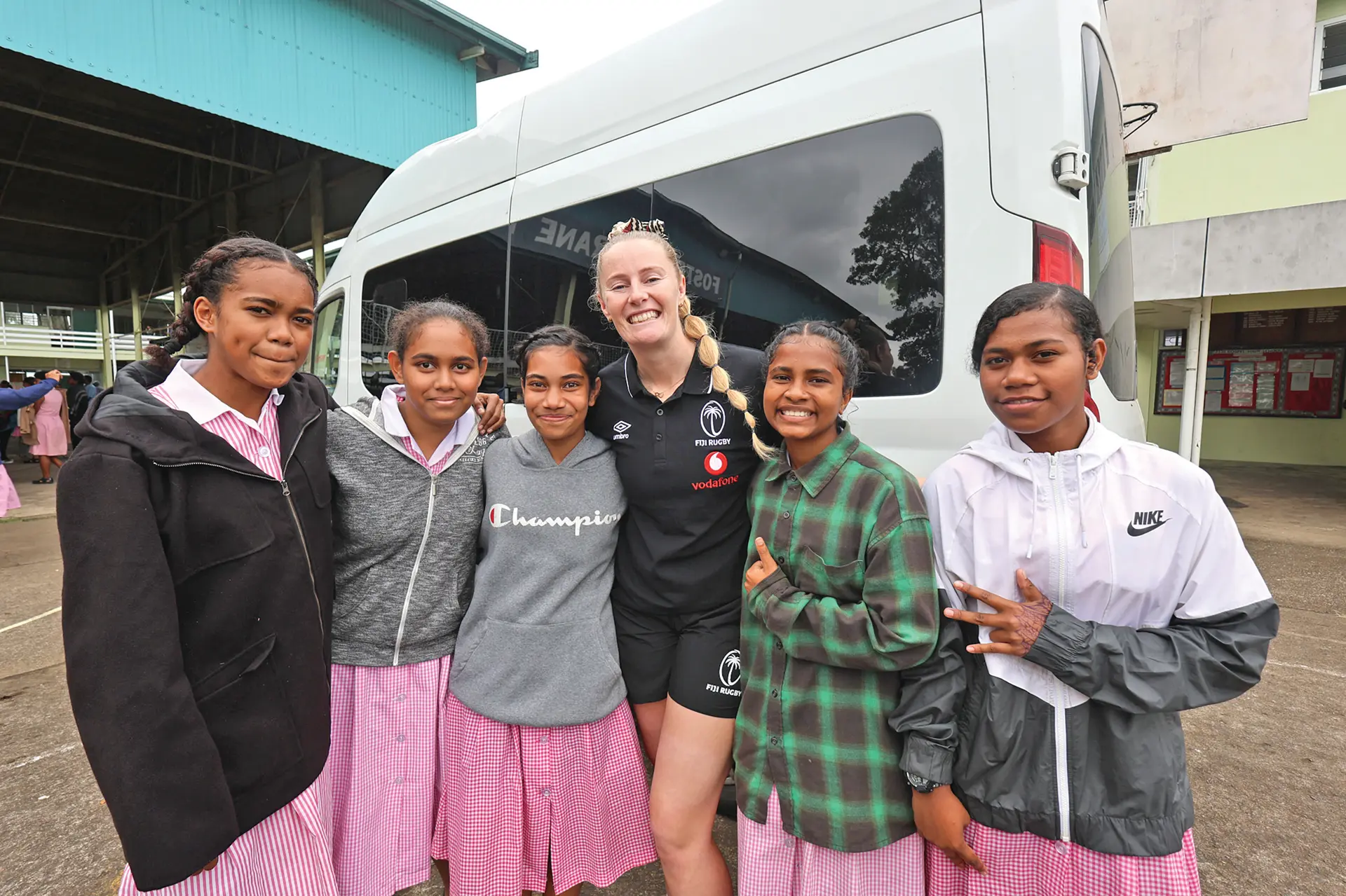 Fijiana XV locks Jade Coates flanked by students of Gospel High School in Suva on August 5, 2026.