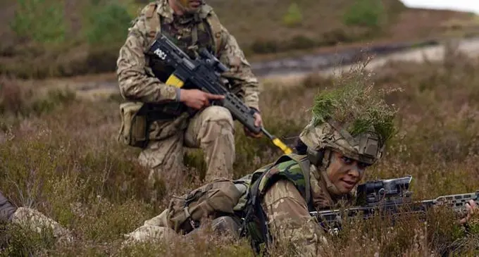 Elena Stanley Balawakula (lying on the ground) with a fellow intake during her intensive 14 weeks of training at the British Army Training Centre Pirbright.  