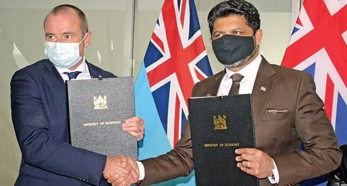 Australia’s High Commissioner to Fiji, John Feakes (left), and Attorney-General and Minister of Economy Aiyaz Sayed-Khaiyum during the signing on December 14, 2021.  Photo: Ronald Kumar