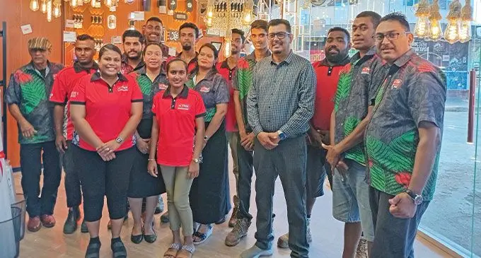 Ashfaaq Khan (fourth from right) with his staff at the opening of their Sigatoka outlet. Photo: Charles Chambers