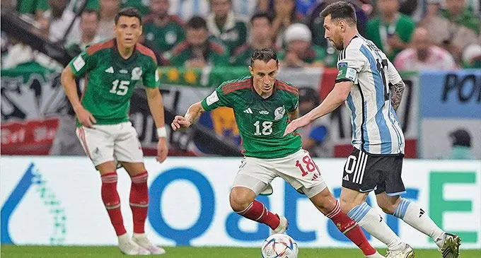 Argentina’s Lionel Messi controls the ball as the Mexcian defenders close in during their FIFA World Cup clash at Lusail Stadium in Qatar on November 27, 2022. Messi scored a goal in the 2-0 win to keep Argentina’s qualifying hopes alive. Photo: London Evening Standard