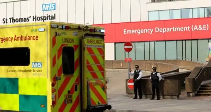 Police waves to an ambulance outside St Thomas' Hospital where British Prime Minister Boris Johnson remains in intensive care in London, Britain on April 8, 2020.(Photo by Tim Ireland/Xinhua)