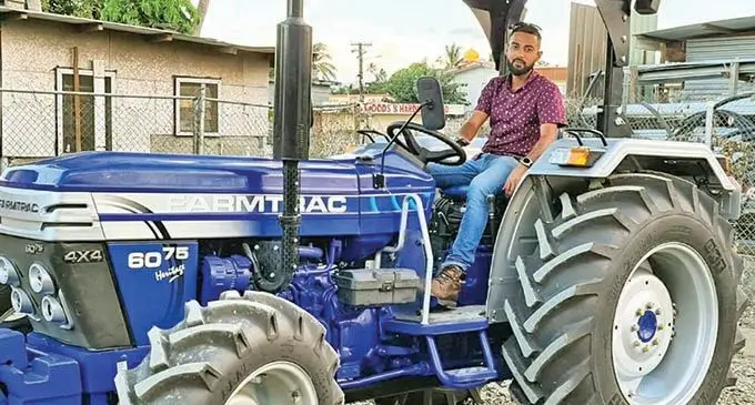 Global Machinery Pte Limited General Manager Hamzah Hussein on one of the tractors. Photo: Supplied 