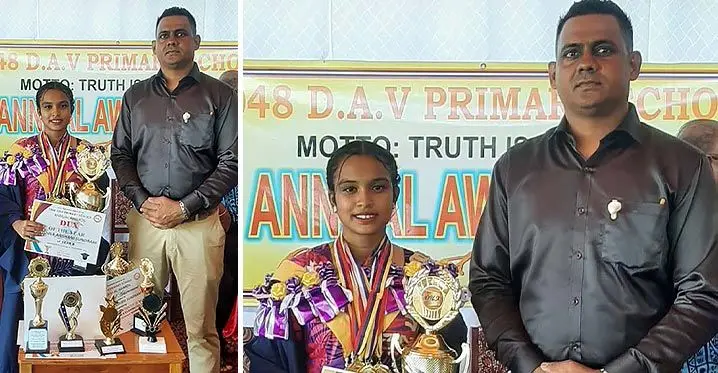 Former DAV Primary School former head girl Avisha Anshani Sundram with year 8 teacher Nilesh Kumar during the school’s annual awards day on December 9,2022