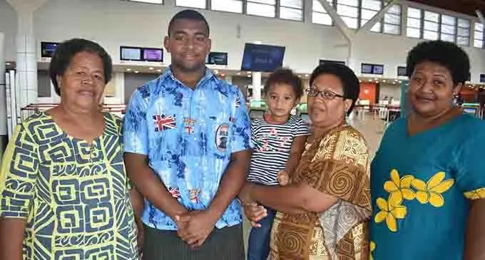 Ravunivadra Uluilakeba with his family at the Nadi International Airport yesterday. Photo: WAISEA NASOKIA