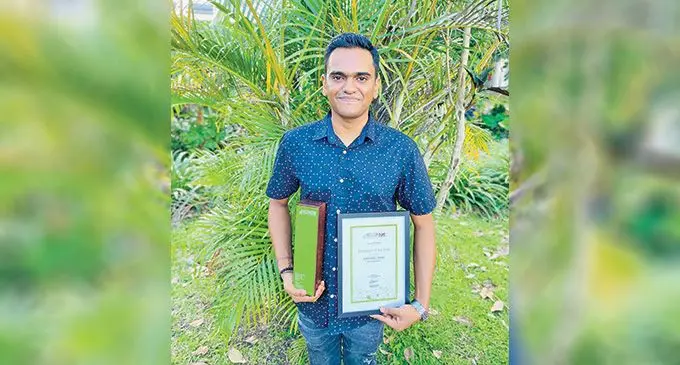 Hasheel Ram with his awards and certificate.