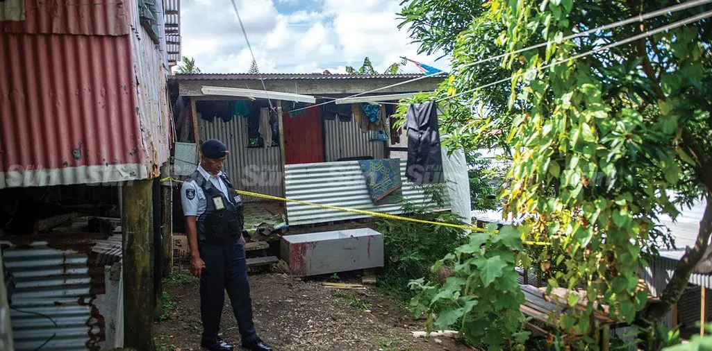 A Police officer at the house where the incident allegedly happened. Photo: Leon Lord