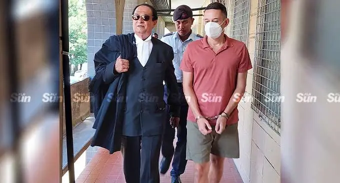 Bradley Robert Dawson, escorted by a Police officer alongside his lawyer, Iqbal Khan (left) at the High Court in Lautoka on December 29, 2022. Photo: Nicolette Chambers