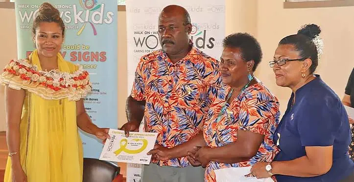 Parents and guardians of children living with cancer together with medical professionals at the launch were presented with certificates and gift hampers by Minister for Women, Children and Social Protection Lynda Tabuya (left)to acknowledge all their efforts in ensuring that each child is afforded the best care at home and at the hospital. Photo: DEPTFO News