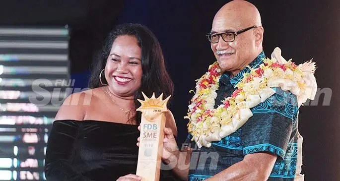 Maria Ronna Luna Pastorizo-Sekiguchi had a reason to smile after receiving the Women Entrepreneur of the Year award from the President Major General (Ret’d) Jioji Konrote at the 2018 Fiji Development Bank National Small and Medium Entreprises awards at the Grand Pacific Hotel. Photo: Ronald Kumar