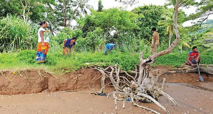 C3 Team contemplating the effects of coastal erosion in Naividamu. copy