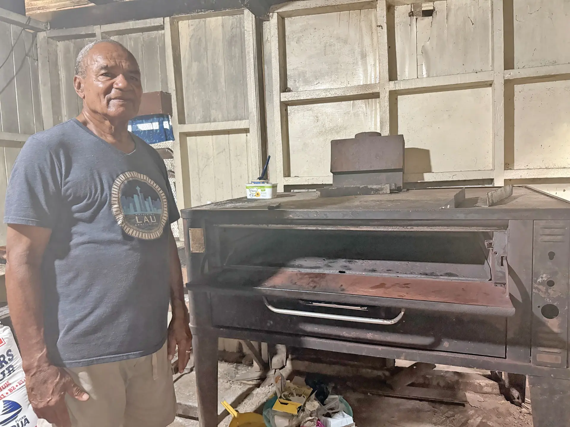 Nemani Tausere stands beside the oven he uses for his bakery business in Tubou Village in Lakeba, Lau. 