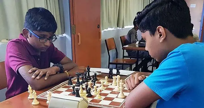 Mukesh Paranthaman (left) ponders on his next chess move. Photo: Fiji Chess Federation