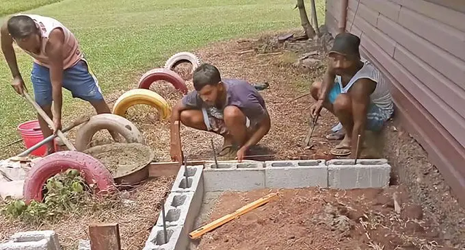 Members of the Naleba Football Federation Sports Club during the Naleba Primary School Kindergarten ablution block during the construction phase.