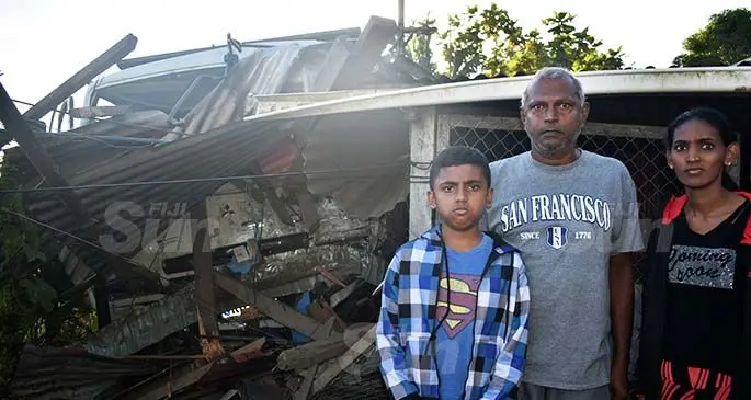 From left: Navish Navin, Rakesh Kumar and Shital Lata outside their damaged house at Kerebula, Nadi on July 31, 2020. Photo: Waisea Nasokia