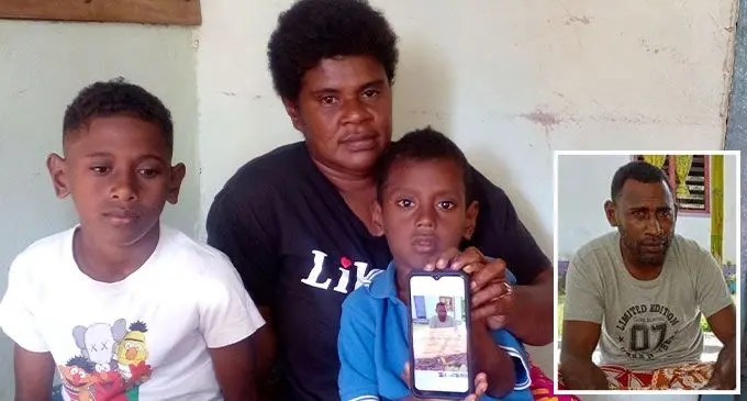 Valeria Wainovo and her sons (left)Sailosi Drigi and Anare Namoce hold up a picture of the late Laisenia Vuluma at their home in Matawalu village, Lautoka on July 19, 2022. Photo: Salote Qalubau. Inset: The late Laisenia Vuluma.