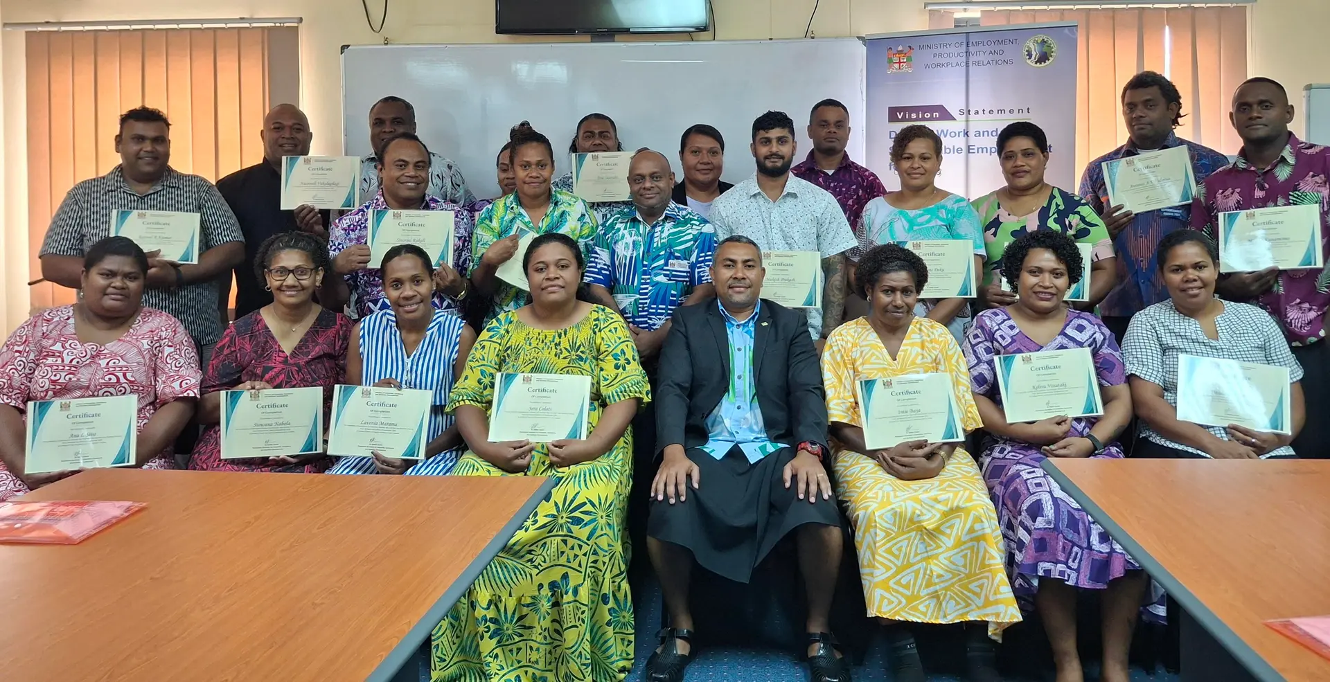 Divisional Labour Officer West Sunia Tuirara, Trainer, Aslam Khan with the returned seasonal workers at the Ministry of Youth and Sports conference room in Lautoka. 