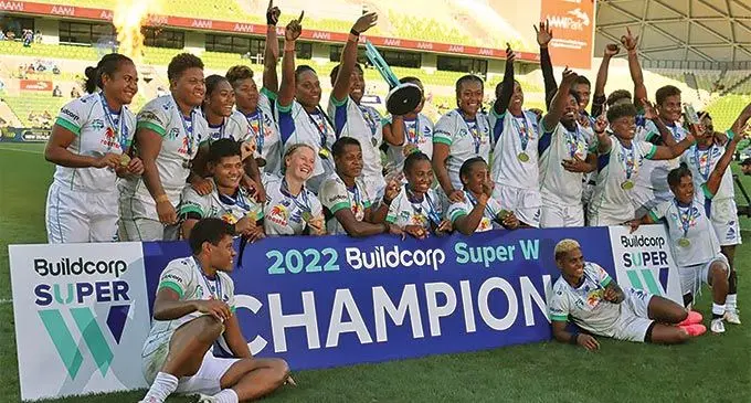 Rooster Chicken Fijiana Drua team after their win against the Waratahs. Bitila Tawake is holding the trophy.