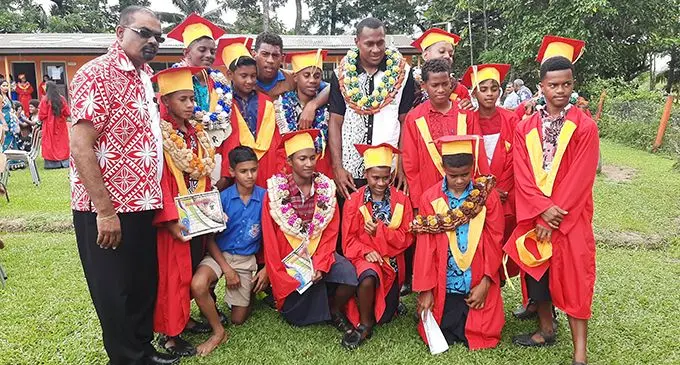Head teacher Muniappa Goundar and 7s captain Paula Dranisinukula with the 2019 Rewa Soccer Team Under-14, Year Eight students. Photo: Shreeya Verma