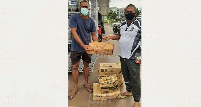 Nadi striker and leading goal scorer Sakaraia Naisua (left) receives a relief pack from team manager Abdul Khan. Photo: Waisea Nasokia