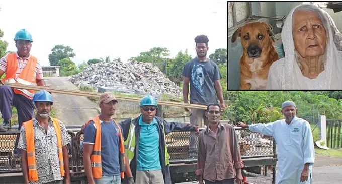 Carpenters from G.M.R MUHAMMAD & SONS PTE LTD hardwares offloading timber to help rebuilding Meena Khan’s house in Samabula Suva.From left Jagdish Chand,Josateki Nakani,Milio Vuetibau,Naushad Ali,Ilaitia Lewanivanua,Amin Mohammed and Akib Mohammed in Suva. Insert: Mrs Khan with her dog “Do” on May 2,2019.  Photo: Simione Haravanua