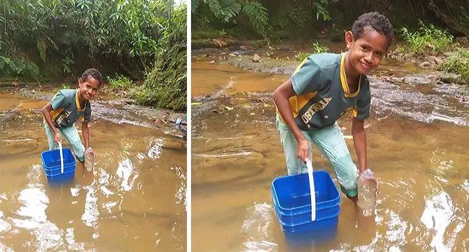 Kelera Ratumaiyale of Qiolevu settlement collecting water from a nearby creek that is sourced underground.
