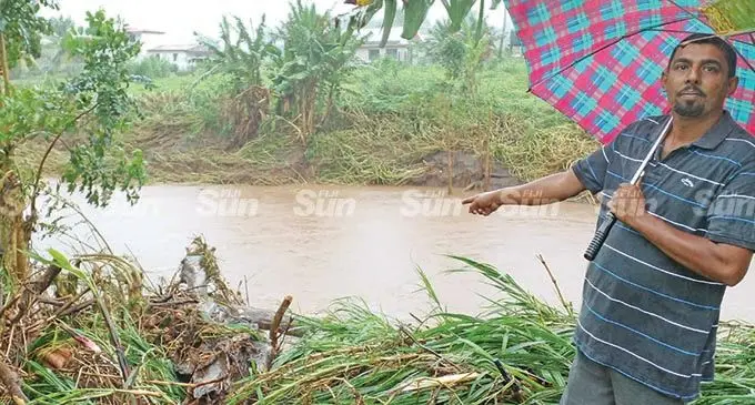 Nilesh Chand points at his banana plantation damaged by flood waters at his home in Drasa, Lautoka on February 6, 2022.  Photo: Salote Qalubau
