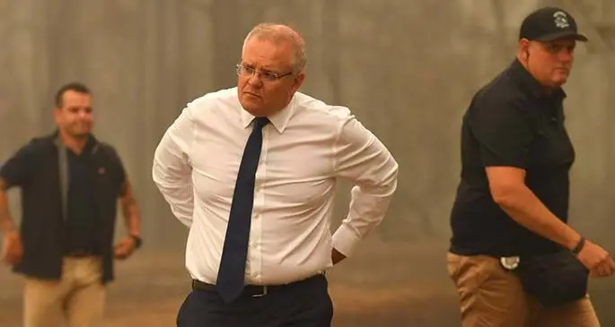 Australian Prime Minister visiting an area ravaged by the bushfires.