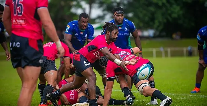 Melbourne Rebels halfback Moses Sorovi delivers a pass as Fijian Drua’s Rusiate Nasove and Chris Minimbi look on during the pre-season trial match at Prince Charles Park, Nadi, on January 28, 2023. Photo: Leon Lord