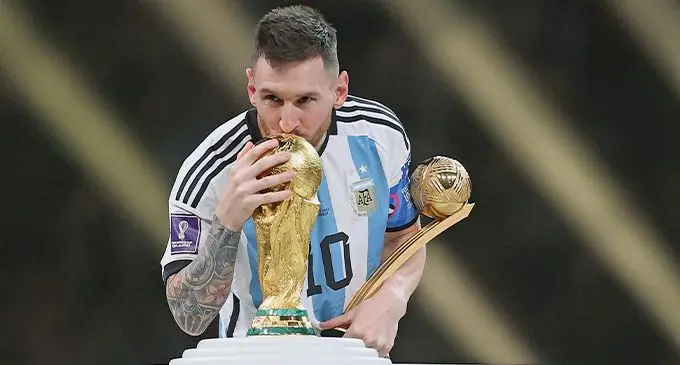 Argentina captain Lionel Messi kisses the World Cup trophy during the presentation ceremony
