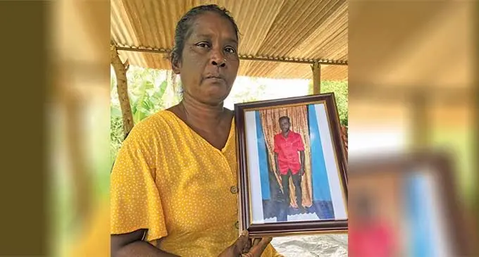 Karuna Devi showing the photo of her husband, Rajnesh Chand (inset photo) at Soasoa, Labasa on December 26, 2022. Photo: Shratika Naidu