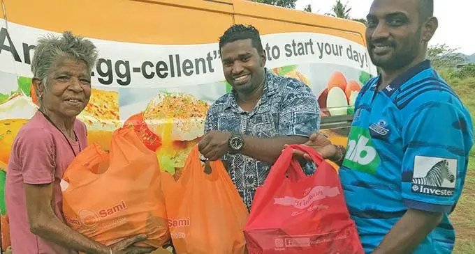Kamla Wati (left) receiving groceries from Ram Sami & Sons (Fiji) Pte Limited staff Nileshwar Sami and Sony Prasad at Nagata, Labasa on October 9, 2020.  Photo: Shratika Naidu