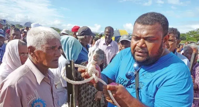 Home-CARE Initiative team Ba personnel Buatavatava Nauluma­tua escorts elderly Ba residents past the rope at the Ba Market Grounds on May 25, 2018.
