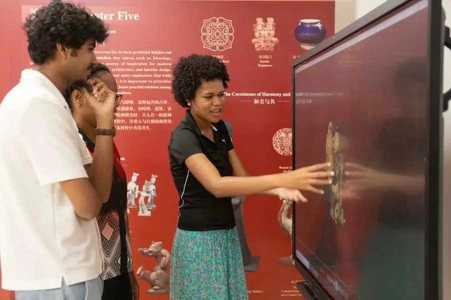 Visitors inspect a digital model of the Changxin Palace Lamp at the Confucius Institute at the University of the South Pacific in Suva, capital of Fiji, April 27, 2026.
