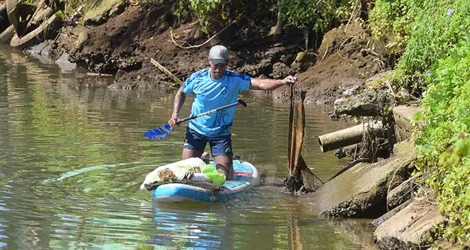 Peni Kuinikoro collecting the rubbish dumped in the Lami creek during the clean up on March 27, 2021. Photo: Ronald Kumar