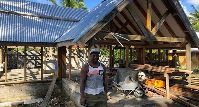 Director, Josefa Bau, in front of a bure expected to be completed early next year. Inset: A beachfront bure and newly opened conference room. Photos: Josefa Babitu