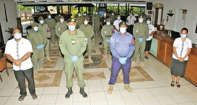 Commander of the Republic of Fiji Military Forces Rear-Admiral Viliame Naupoto (front, second from left), with Tanoa Hotel staff and military personnel at the Government-funded quarantine facility.  Photo: RFMF Media Cell