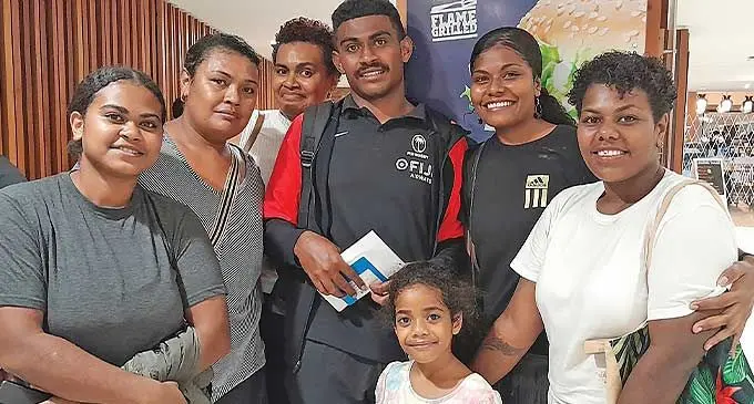 Fiji Airways Fiji men’s rugby sevens rep Solomone Nakulanisa Rauqe with family members at Nadi International Airport on February 12, 2024. Photo: Waisea Nasokia