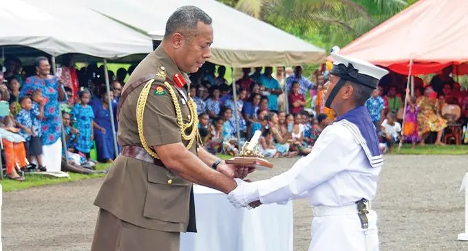 Republic of Fiji Military Forces Naval Division ordinary seaman Penaisia Kula receiving the best division drill award from the RFMF Commander, Major-General Ro Jone Kalouniwai on November 18, 2022. Photo: RFMF Media Cell