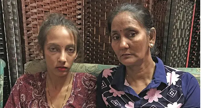 Chandra Wati (right) with her daughter Pooja Chand showing a photo of the family’s happier days in Labasa on March 14, 2019. Photo: Shratika Naidu