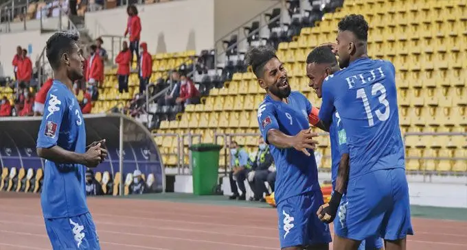 Digicel men’s football national team captain Roy Krishna (left) congratulates Sairusi Nalaubu (middle) after he scored his second goal against New Caledonia in Doha, Qatar, on March 18, 2022.