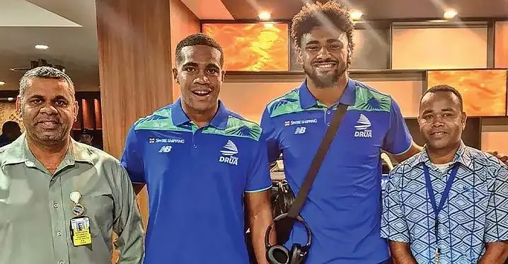 Swire Shipping Fijian Drua development player Aisea Tuisese (second from left) and lock Isoa Nasilasila (third from left) with fans at Nadi International Airport on February 15, 2023. Photo: Drua Media