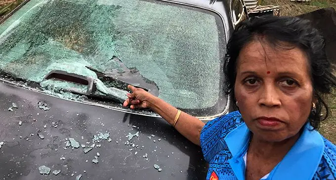 Puspha Lata points at the damage done on her car at Benau, Labasa on May 20, 2019.  Photo: Shratika Naidu